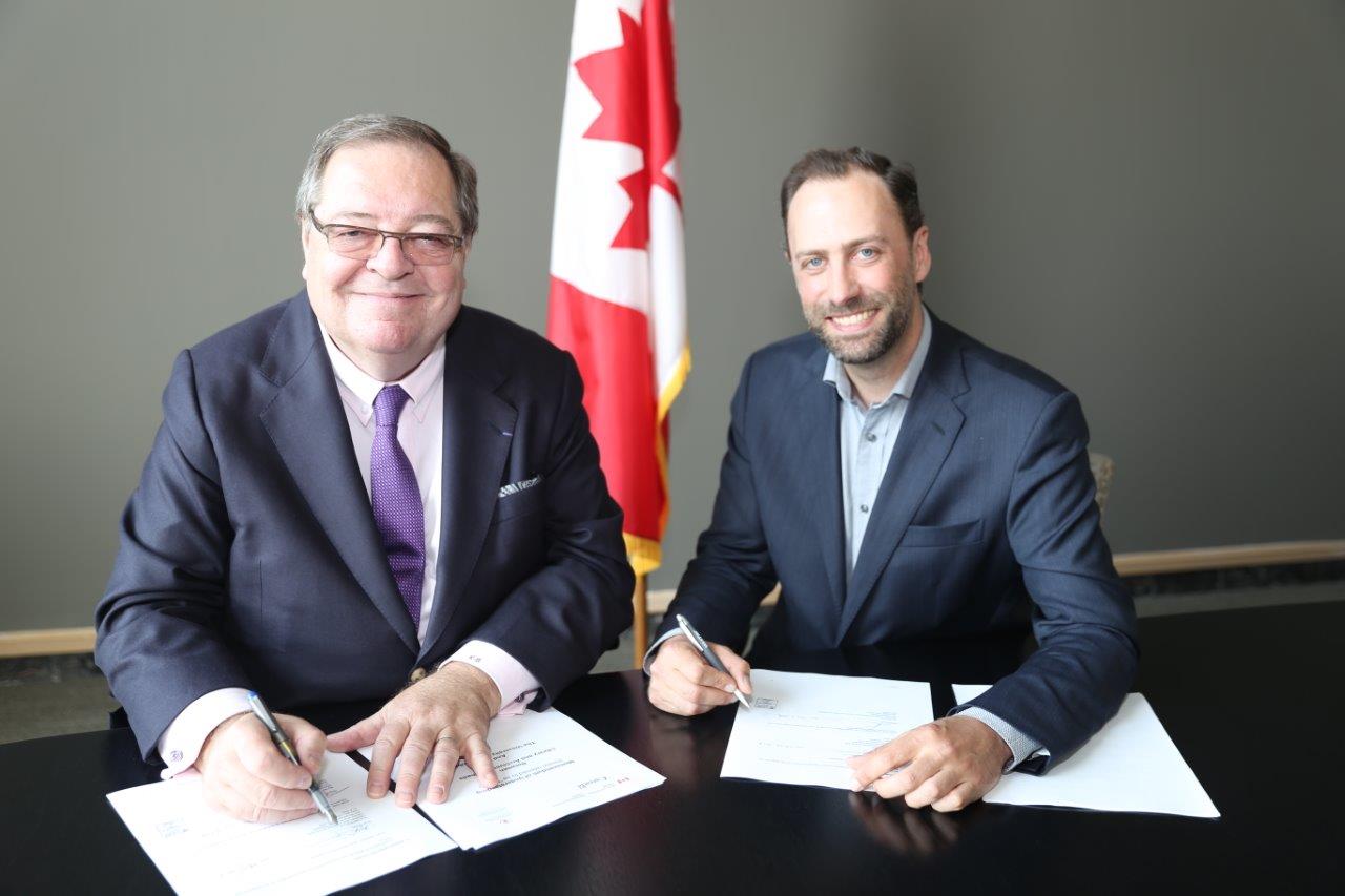Dr. Guy Berthiaume and Ry Moran formalizing their new agreement.