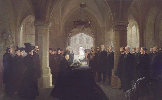 Painting depicting an obscure gothic room with queen Victoria kneeled on a coffin in the middle surrounded by black dressed standing attendees