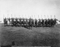 A row of uniformed men on horseback