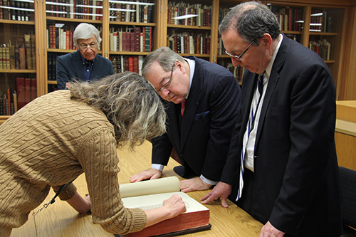 From left to right: Leah Cohen, Dr. Norman Barwin, Dr. Guy Berthiaume and the Honourable Rafael Barak pore over the colophon—a statement about publication of a work—at the end of Josephus Flavius’ The Jewish War and Jewish Antiquities.